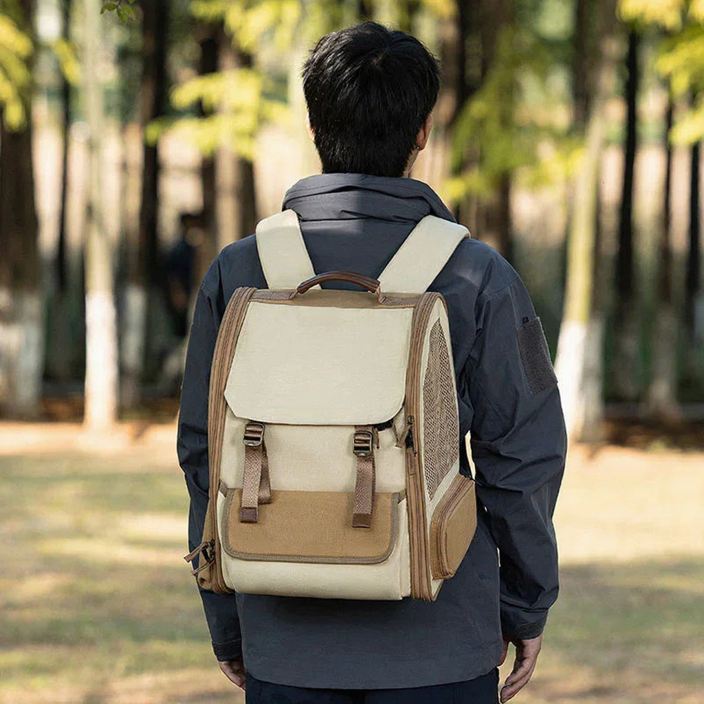 Catvera Bubble Window Travel Carrier - Image 9|||PROMPT|||Cleaned image. Original analysis: Found 2 brand name labels on the backpack: one brown leather patch/label on the front flap area and one on the bottom section of the bag