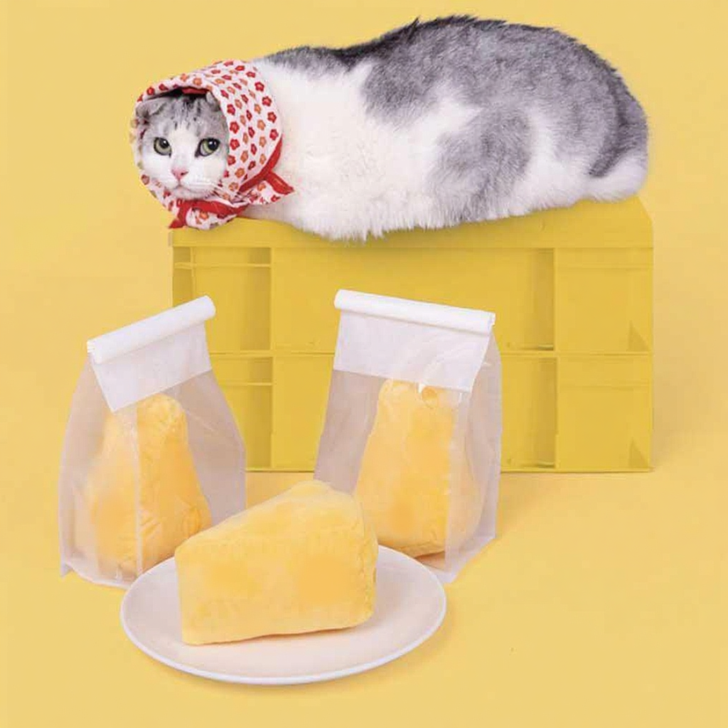 Catvera Cheese Catnip Plush Toy - Image 9|||PROMPT|||Cleaned image. Original analysis: Found 1 brand name/logo on the product - a small tag or label visible on one of the cheese prop bags in the lower portion of the image