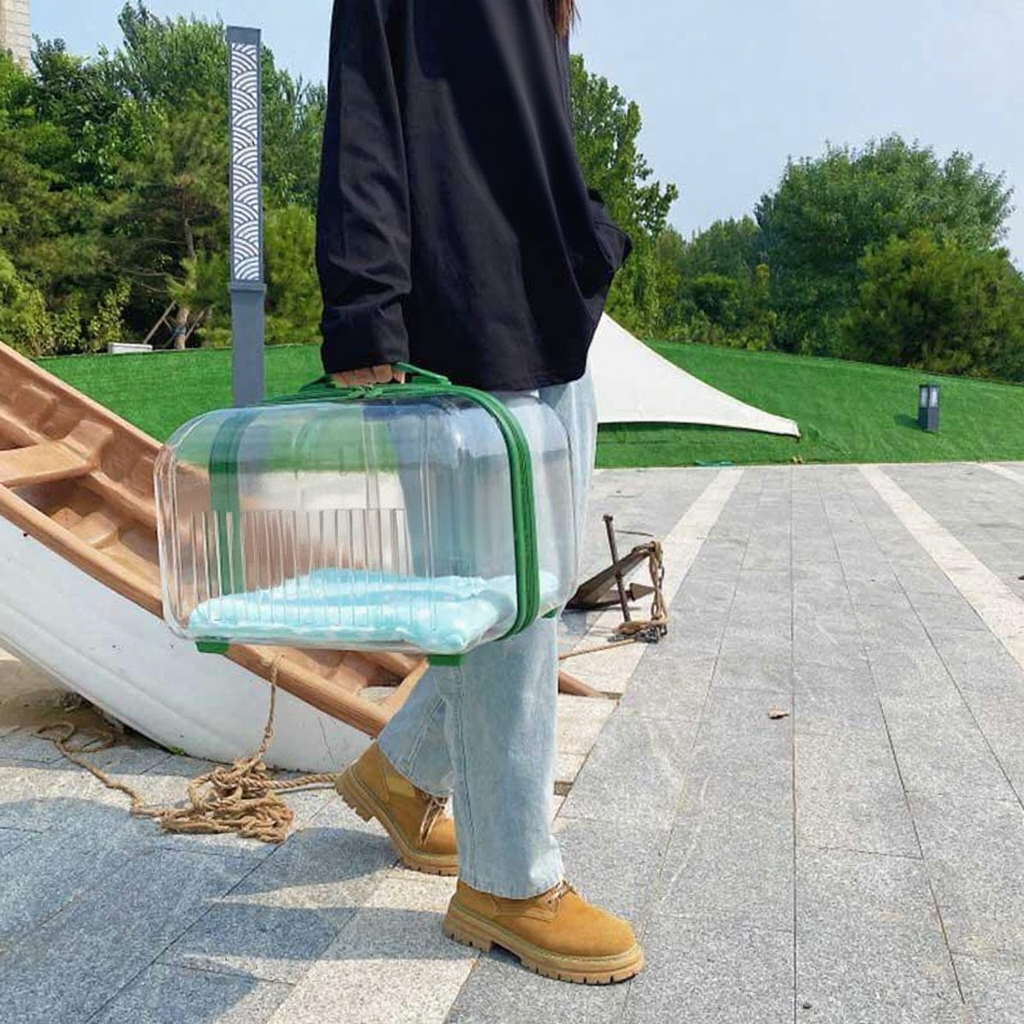 Catvera Clear Wheeled Cat Trolley - Image 13|||PROMPT|||Cleaned image. Original analysis: Found text/branding on the black jacket/hoodie being worn, and a visible brand name on the clear carrier bag