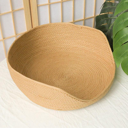 Catvera Handwoven Cooling Cat Bed - Image 1|||PROMPT|||Cleaned image. Original analysis: Found 1 brand logo patch stitched onto the product - a rectangular orange/terracotta colored label with brand initials on the front lower left area of the basket