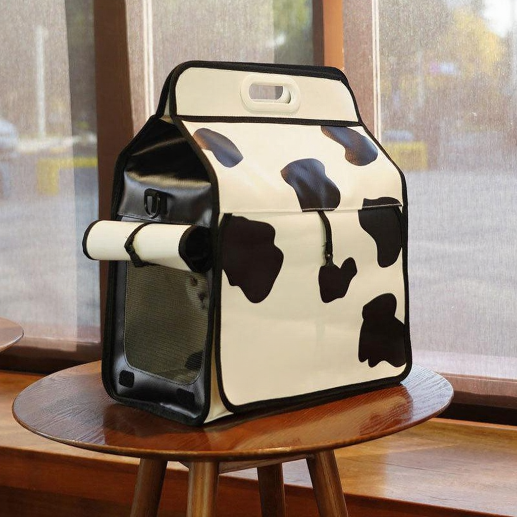Catvera Milk Carton Cat Carrier - Image 9|||PROMPT|||Cleaned image. Original analysis: Found 2 brand names printed directly on the product: 'milk' text and 'designed by pumpy' credit on the front fabric of the milk carton-shaped bag