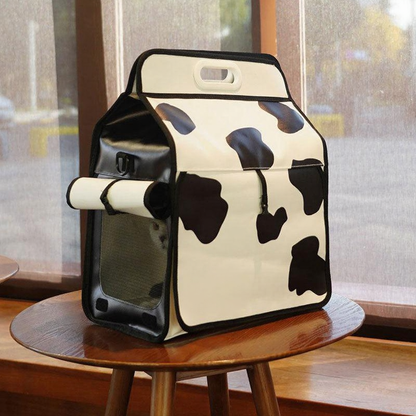 Catvera Milk Carton Cat Carrier - Image 9|||PROMPT|||Cleaned image. Original analysis: Found 2 brand names printed directly on the product: 'milk' text and 'designed by pumpy' credit on the front fabric of the milk carton-shaped bag