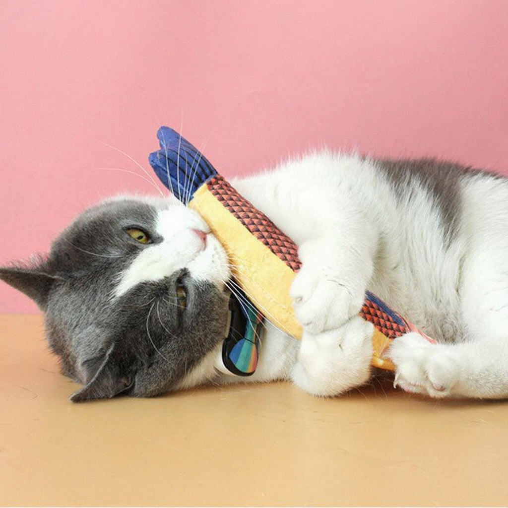 Catvera Plush Catnip Fish Toy - Image 15|||PROMPT|||Cleaned image. Original analysis: Found 1 brand logo on the toy/product itself - a red shield-shaped logo visible on the yellow fabric toy that the cat is playing with