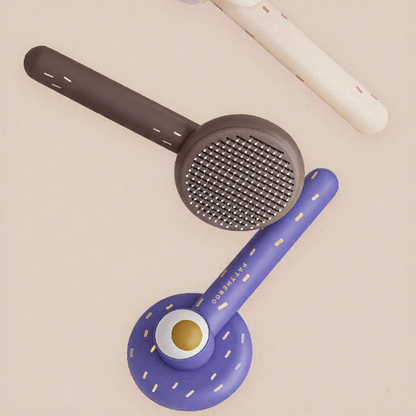 Catvera Self Cleaning Cat Hair Brush - Image 5|||PROMPT|||Cleaned image. Original analysis: Found 1 brand name printed directly on the product (BEAUTIFUL on the black grater handle) and partial branding visible on the white and purple items in background